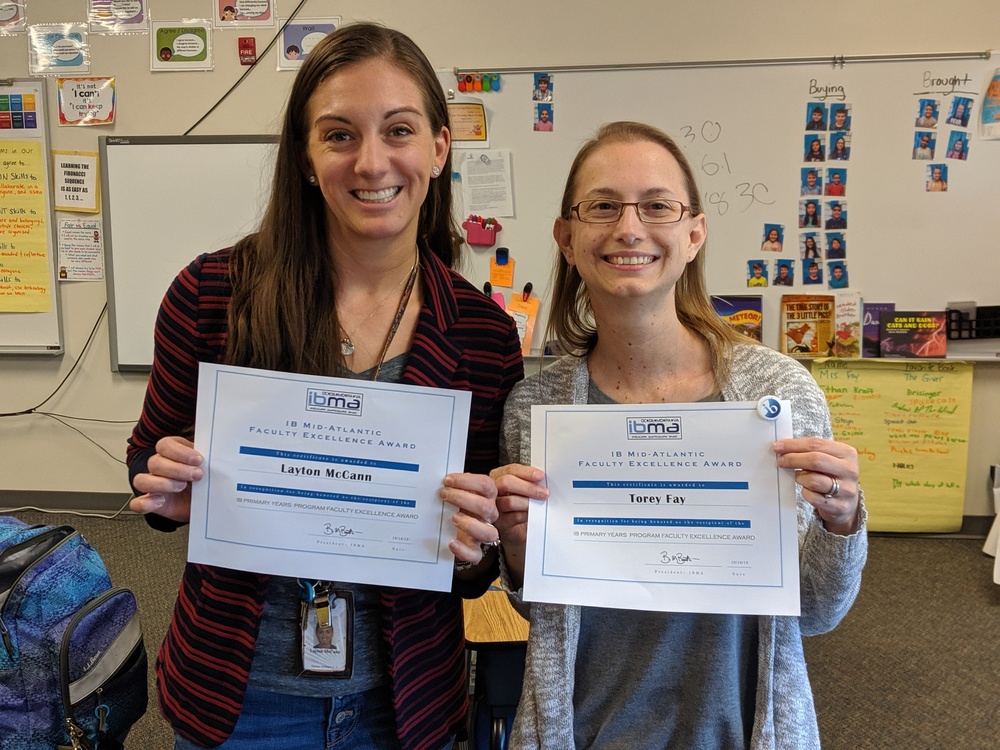 Teacher Ms. McCann and Ms. Fay holding certificates for the IBMA Faculty Excellence Award 