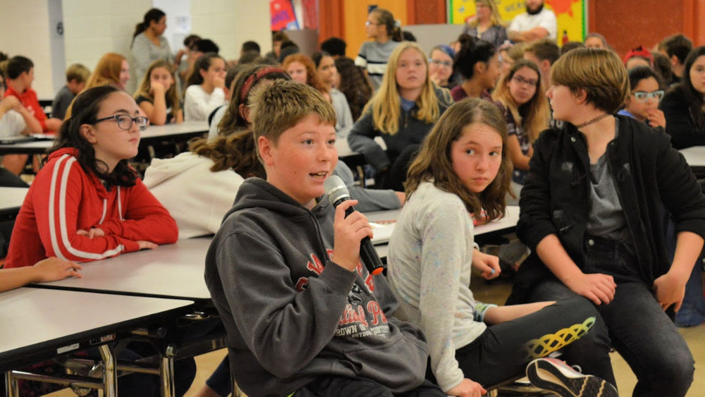 Student asks questions of SCA representative during town hall
