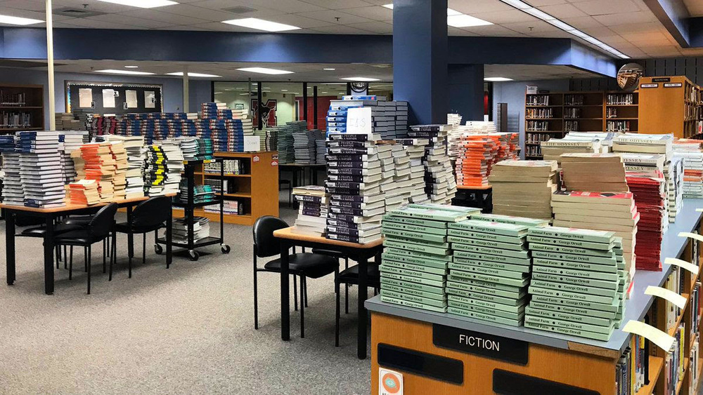 Stacks of textbooks in the library awaiting distribution to students