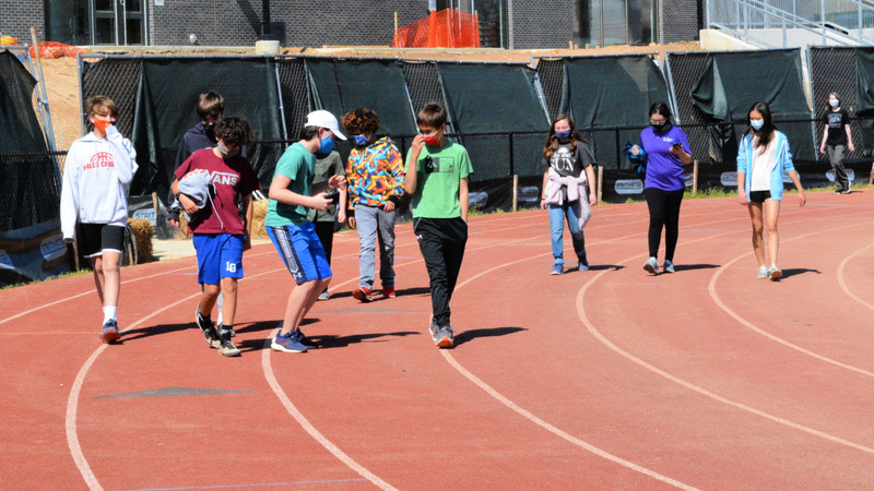 Students walking around a track