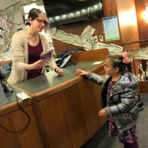 Student checks out a book at Mary Riley Styles public library