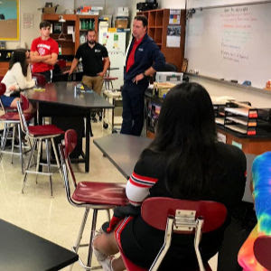 Students listen to a volunteer take about his career